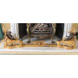 A gilt metal fire surround , featuring two recoiled ebonised cherub figures, 153cm in length