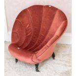 A late Victorian scalloped back nursing chair, raised on ebonsied turned front legs, terminating