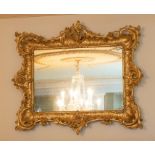 A 19th century giltwood  mirror, in a rococo manner, the mirror plate with some discolouration