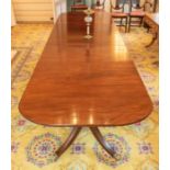 A 19th century mahogany extending triple pedestal dining room table, with three removable leaves,