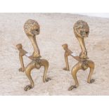 A pair of early 20th century cast brass fire dogs  Please note this item is at an offsite