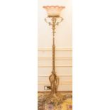 An early 20th century rococo style giltmetal floor light, with curved colour glass shade, 168cm H