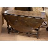 An 18th Century planktop gateleg table in oak having single side drawer with iron swing handle