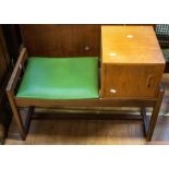 A 1960s teak hall phone table with green leatherette seat and single cupboard