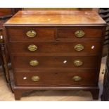 A late Georgian chest of drawers in oak, two short over three long drawers, on bracket feet, with