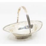 A George III silver bright-cut engraved navette shaped small basket, reeded rim and swing handle,