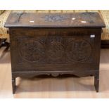 A 20th Century carved linen/blanket box in oak, having iron hinges, carved top and front