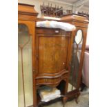 An Edwardian display cabinet, central cupboard and inlaid doors, with internal glass shelves