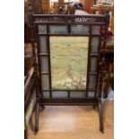 A  late 19th Century fire screen, stained glass and watercolour on silk panels, on casters