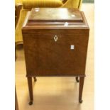 A George III cellarette, walnut and mahogany, having tapered legs and casters, lift up lid to reveal