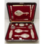 An Edwardian fifteen piece silver mounted dressing table / travelling set comprising: a pair of