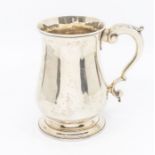 A George III silver plain baluster tankard, S-scroll handle with acanthus thumbpiece, on stepped