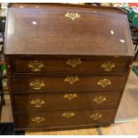 A George III oak bureau  having four single drawers, with brass swing handles and galleried top