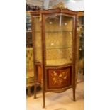 A reproduction Louis XV style glass vitrine, having two glass shelves above a cupboard door,