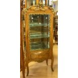 A reproduction Louis XV style glass display cabinet, having flat-fronted door, inlaid and spelter