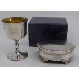 A silver oval box, the hinged engine turned cover with cast border and on four winged paw feet, by