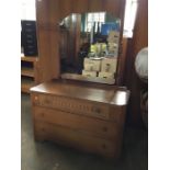 An Austinsuite honey oak dressing table, the back with bevelled mirror above one three quarter