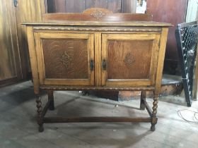 A 20th century oak and oak veneer small sideboard/unit, carved frieze, panels to front of both