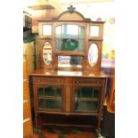 A good Edwardian mahogany cabinet, circa 1905, the glazed back with central cupboard door flanking