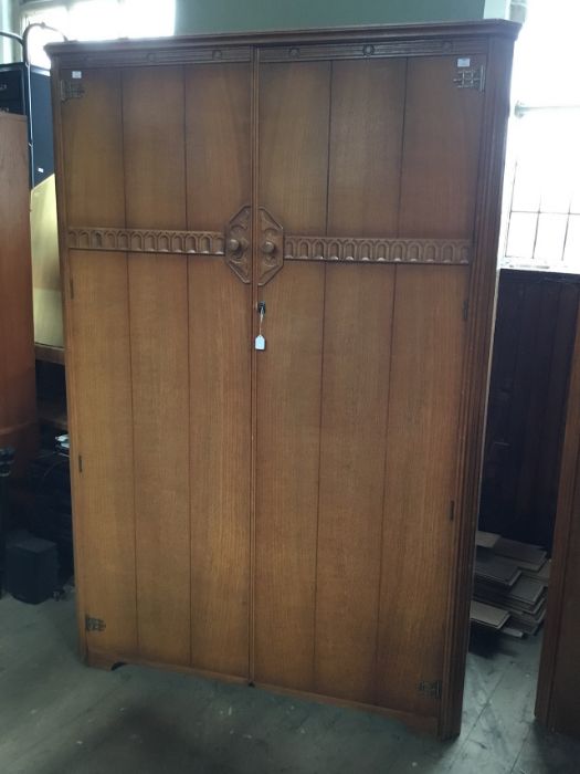 Two Austinsuite wardrobes both in honey oak with carved frieze leading to door handles, intricate