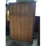 Two Austinsuite wardrobes both in honey oak with carved frieze leading to door handles, intricate