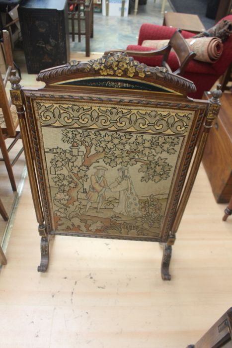 A Victorian firescreen, silk back panel, the front with cross-stitch and tapestry scene depicting
