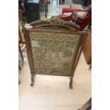 A Victorian firescreen, silk back panel, the front with cross-stitch and tapestry scene depicting