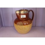 A good Victorian salt glazed stoneware pottery jug with thick silver rim (hallmarked)
