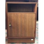 A Meredew furniture bedside cabinet, open shelf above door opening to reveal a shelf, decorative