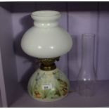 A good pottery and opaque glass oil lamp with clear reservoir