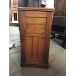 An early 20th century mahogany bedside table of elegant form, the door opening to reveal a shelf,