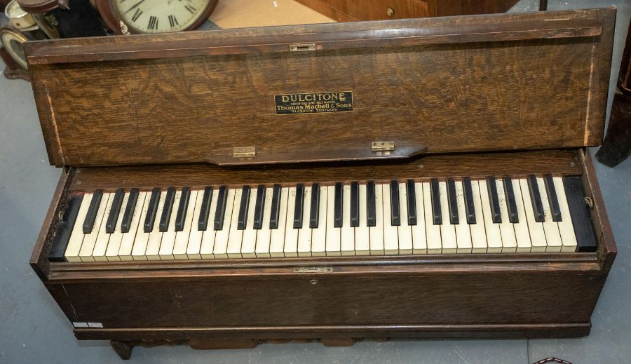 An early 20th century dulcitone portable piano by Thomas Machell & Sons, Glasgow, Scotland. Foldable
