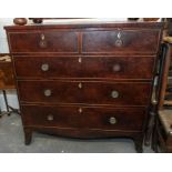 A mid 19th century chest of drawers, two short drawers over three graduated ivory inlaid locks on
