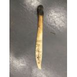 A deer horn late 19th century letter opener with scrimshaw decoration