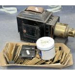 One magic lantern projector and two sets of magic lantern slides one with photographs of an