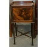 A 19th century mahogany bedside cabinet, carrying handles with a cupboard on cabriole legs united by