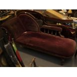A victorian mahogany framed chaise lounge button back with velvet upholstery, on turned column