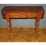 A George III mahogany, crossbanded and strung card table, the swivel folding top on ring turned