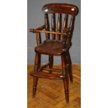 A late 19th beech and elm stick back child's high chair, with retaining bar, saddle seat and foot