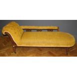A late Victorian carved walnut framed chaise longue upholstered in mustard velvet dralon, having a