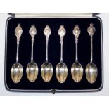 A set of six silver teaspoons each with 20th century British sovereigns, their Queen and one of