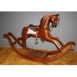 A Stephenson Brother walnut rocking horse of large size with mounted saddle and reins, W196cm