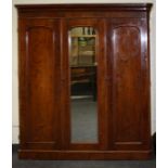 A Victorian mahogany compactum wardrobe, the moulded cornice over a central full length mirror panel