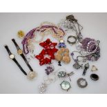A quantity of costume jewellery including ornamental necklaces, various earrings, wristwatches, an