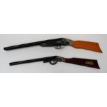 Two tin plate 'pop' toy shotguns, each with wood stock