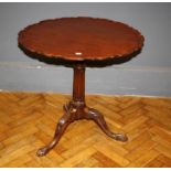A George III style mahogany snap top occasional  table, the pie crust circular top over a birdcage