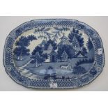 An early 19th century blue and white transferware meat platter, decorated with pagoda and deer in