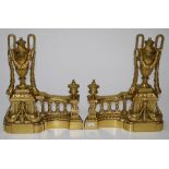 A pair of Louis XVI style brass chenets of typical form having neo classical decoration, H39cm each
