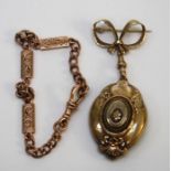 A yellow metal oval Target pendant/locket (back missing) suspended on yellow metal bow pin and