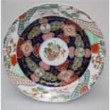 A late 19th century Japanese porcelain charger, centrally decorated with peonies and gourd on a